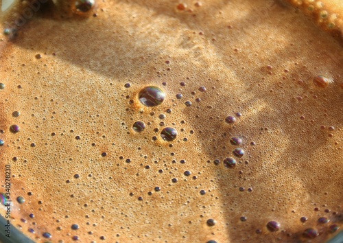 Bubble in coffee foam background. Brown macro coffee texture.