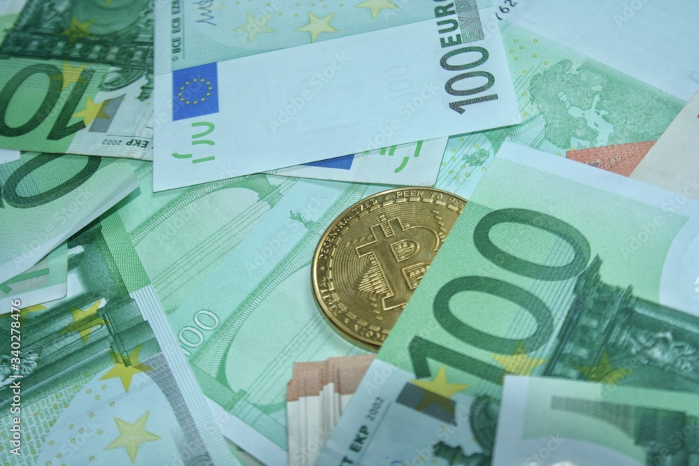 Golden bitcoin coin on euro bankcote. Finance and banking concept. Economy investment. Golden bitcoin coin on euro bankcote. Finance and banking concept. Economy investment.