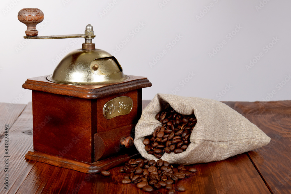 an old grinder and a bag full of coffee beans