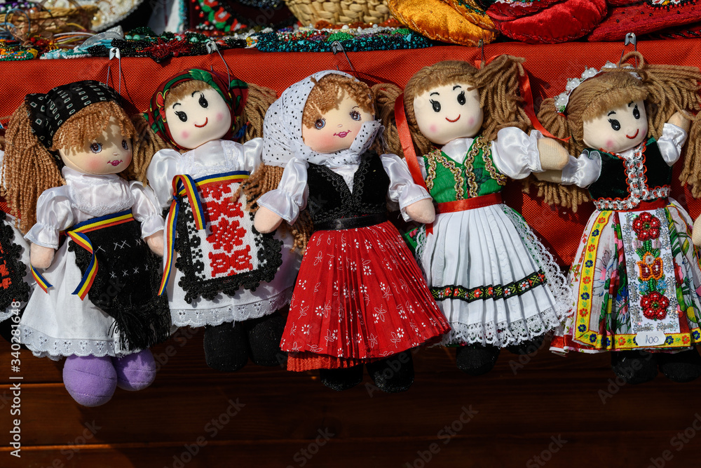 Group of colourful textile hand made decorations, dolls for children, available for sale at a traditional weekend market in Bucharest, Romania
