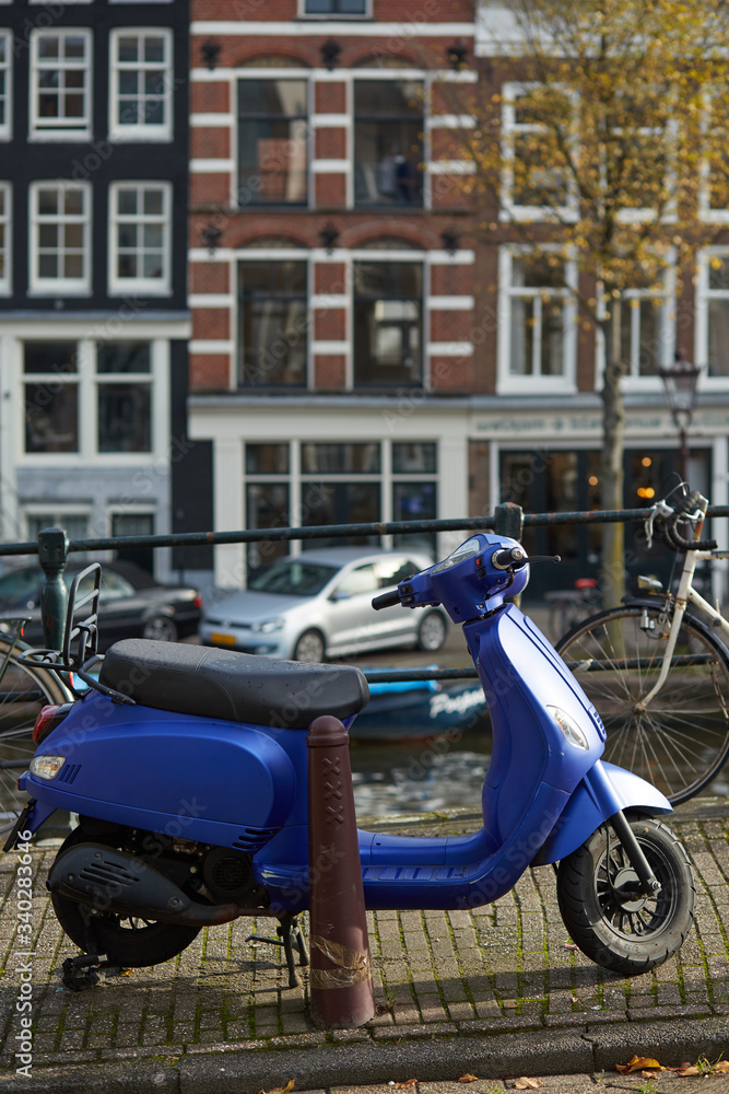 Blue scooter in the streets of Amsterdam