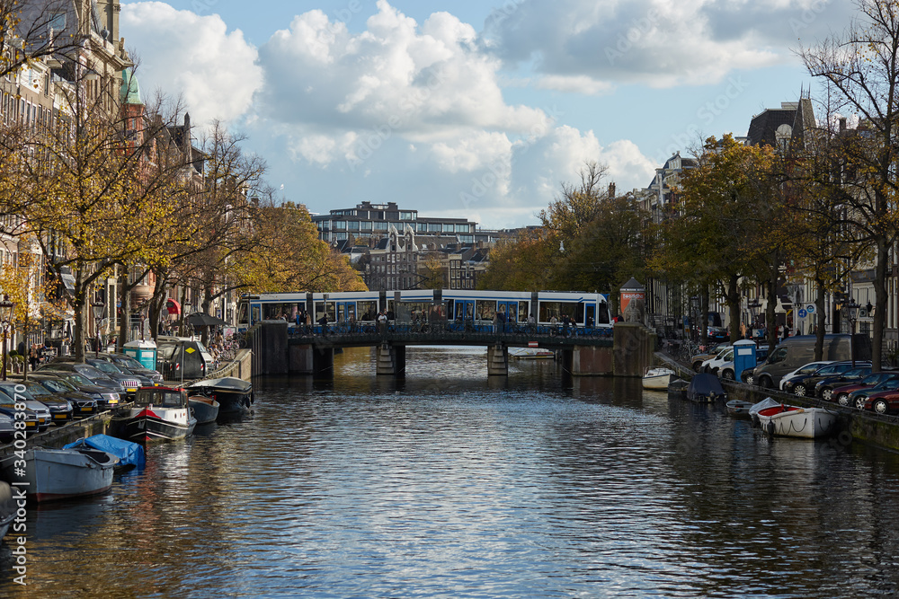 Tram crossing a bridge over an Amsterdam canal