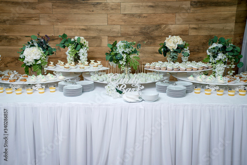 stylish luxury decorated candy bar for the celebration of a wedding of happy couple, cathering in the restaurant