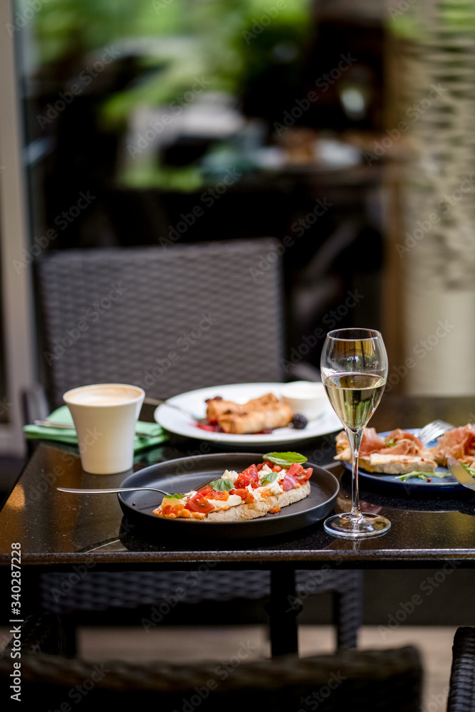 Bruschetta with cheese and tomato and glass of wine