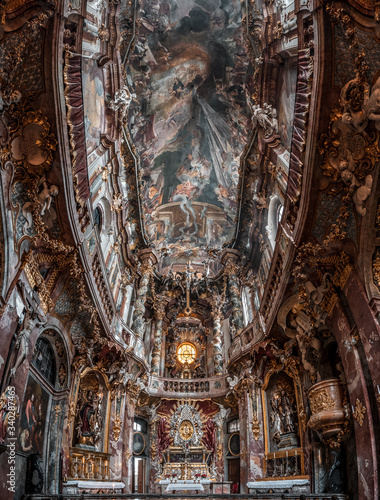 Ultrawide upward view of ceiling fresco altar facade inside Baroque style church Asamkirche in Munich, Germany photo