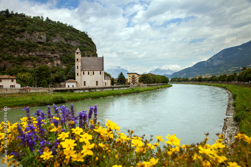 St Apollinare church and Adige river in Trento, Italy