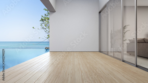 Empty terrace floor near living room and white wall in modern beach house or luxury pool villa. Wooden deck 3d rendering with sea view. photo