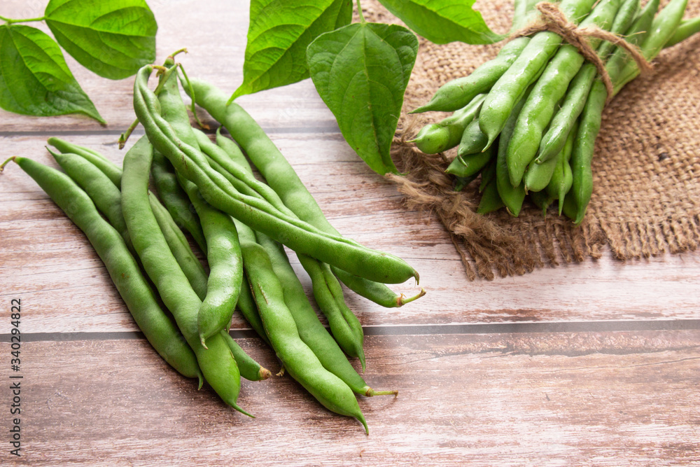Green beans close up on wooden background Green beans close up on wooden background