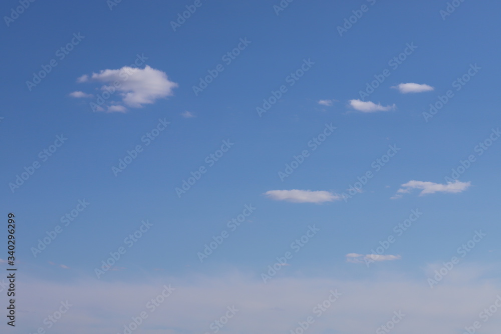 Spring blue sky with clouds. Background of blue sky and clouds. Spring blue sky with clouds. Background of blue sky and clouds.