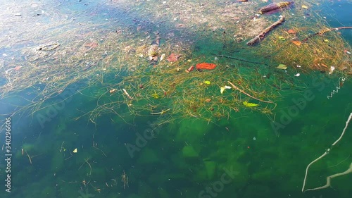 Plastic pollution of the ocean, plastic bags, bottles, bags float in water 