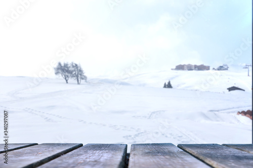 Empty wooden base suitable for mockup. Snow background theme. © filippo