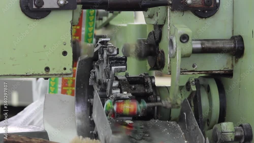 The mechanism of the packaging machine packages the candy bars in the paper. The video was taken in close-up. The mechanism of the packaging machine packages the candy bars in the paper. The video was taken in close-up.