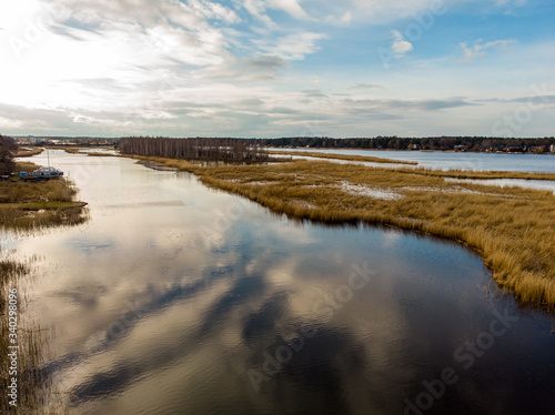 River Lielupe areal view on a sunny spring day with cloudy sky.