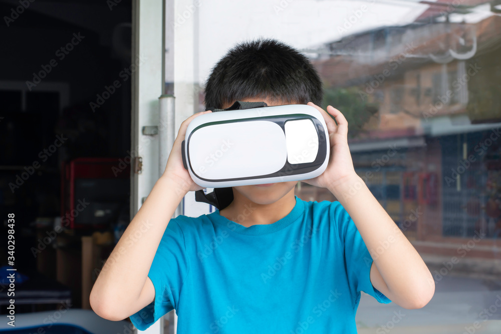 Hand asian boy holding VR camera on the head. Hand asian boy holding VR camera on the head.
