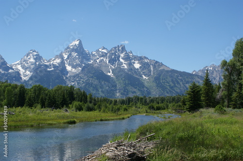 Scenic View Of Lake And Mountains Against Blue Sky