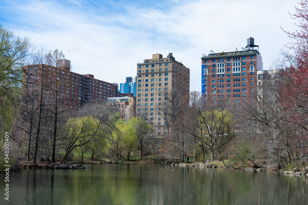 Residential Buildings on the Upper West Side surrounding the Pool at the Northern Area of Central Park in New York City during Spring