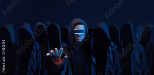 Hackers army. Dangerous hooded group of hackers. Internet, cyber crime, cyber attack, system breaking and malware concept. Dark face. Anonymous.