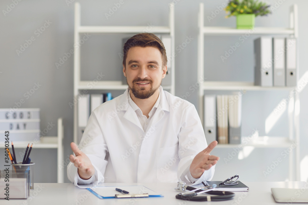 Confident medical doctor talking sitting in a hospital. Confident medical doctor talking sitting in a hospital.