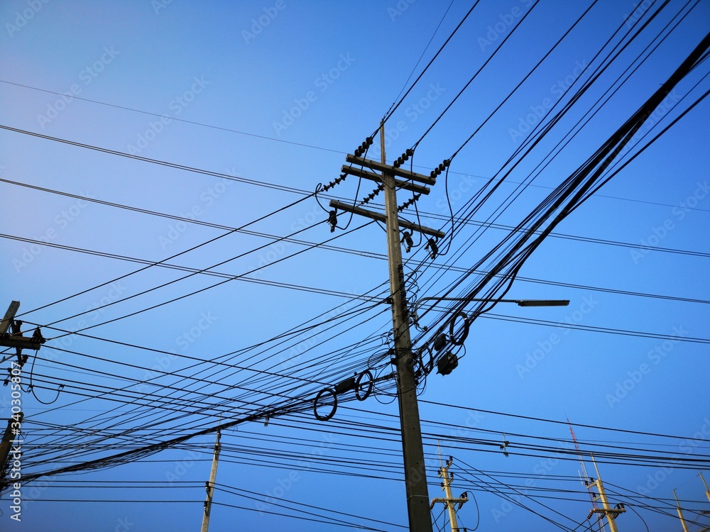 Electric poles with wires and blue sky
Electric poles with wires and blue sky