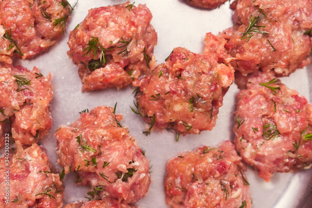 Prepared raw lumps of minced meat on a metal texture. Close up food background, Prepared raw lumps of minced meat on a metal texture. Close up food background,