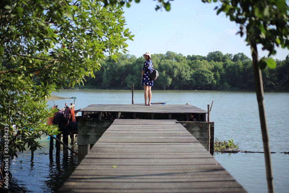 Woman on a wooden bridge at Mangrove Forest, Rayong, Thailand