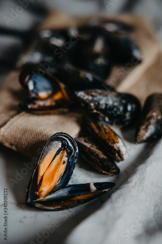 Fresh uncooked raw big mussels on the marble table, Top view. photo