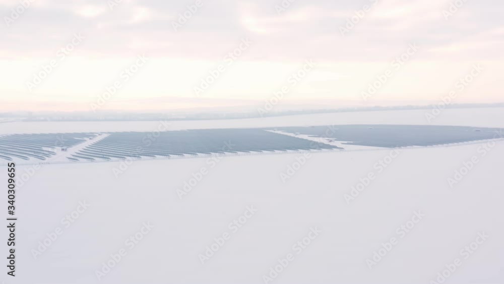Aerial perspective Solar panel farm Green Energy at winter snow sunny day drone shot of Ecology Power Conservation Aerial perspective Solar panel farm Green Energy at winter snow sunny day drone shot of Ecology Power Conservation