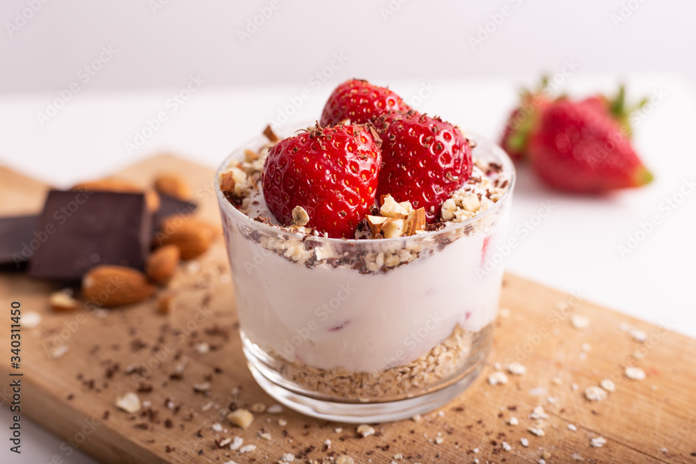 Yogurt with oat, strawberries, chocolate and almonds. Healthy and nutritious snack. Oatmeal yogurt, good protein food for muscles. Yogurt with oat, strawberries, chocolate and almonds. Healthy and nutritious snack. Oatmeal yogurt, good protein food for muscles.