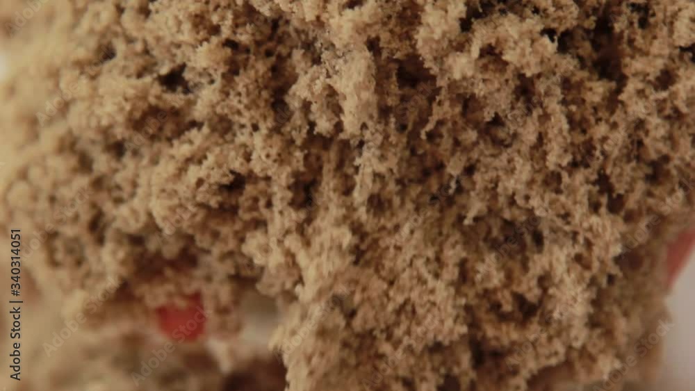 Brown kinetic sand quickly slides and falls from female hands, close-up. A teacher shows how to use an educational toy in a class filled with sunlight. Brown kinetic sand quickly slides and falls from female hands, close-up. A teacher shows how to use an educational toy in a class filled with sunlight.