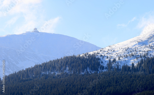 KARPACZ, POLAND - MARCH 08, 2020: Panoramic view of the Giant Mountains with the highest peak - Sniezka (1602 m. above sea level). Winter landscape. Karpacz, Poland, Europe. photo