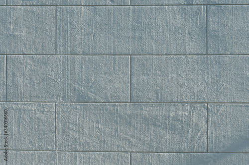 Billede på lærred Big stone look facade plastered building wall painted white and looking like big