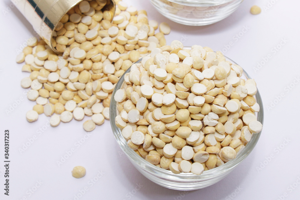 Group of a healthy roasted gram in a bowl with brass measuring jar on a white background Group of a healthy roasted gram in a bowl with brass measuring jar on a white background