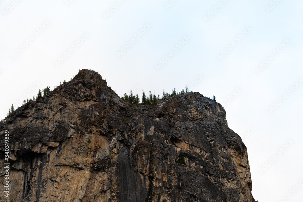 rock cliff against sky. Travel in mountains, stone wall for mountaineering