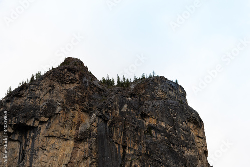 rock cliff against sky. Travel in mountains, stone wall for mountaineering