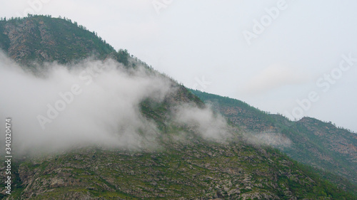 thick clouds over rock ridge, bad weather and waiting for rain in  mountains © Koirill