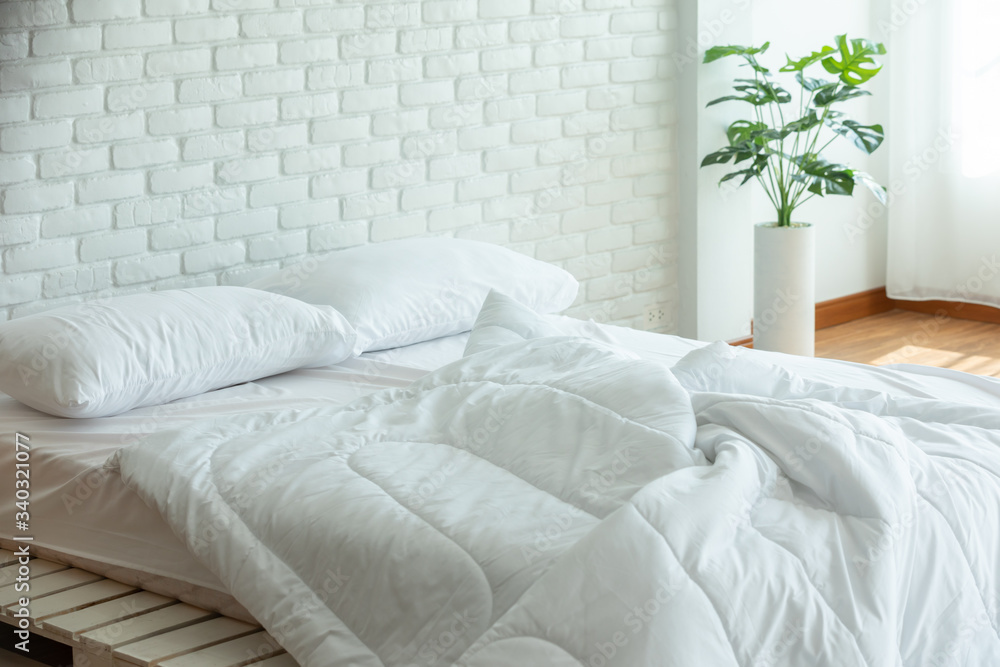 Messed bed with white pillow and blanket with natural light in bedroom in the morning,Messy bed after wake up,Messy bed and Cozy Bedroom Concept Messed bed with white pillow and blanket with natural light in bedroom in the morning,Messy bed after wake up,Messy bed and Cozy Bedroom Concept