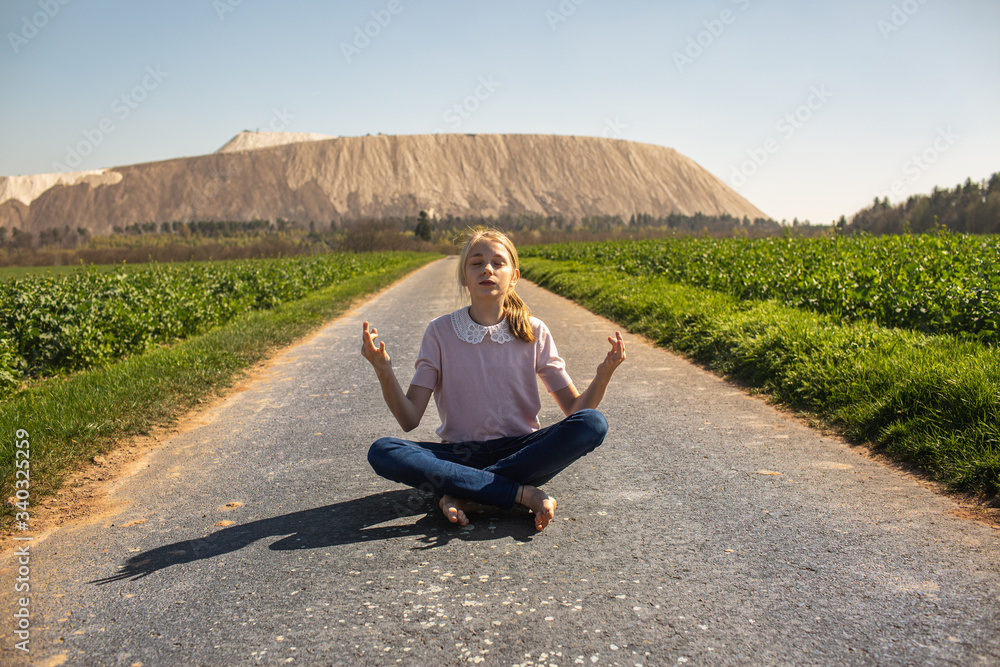 meditating teen infront of a kalimountain, kalimandscharo