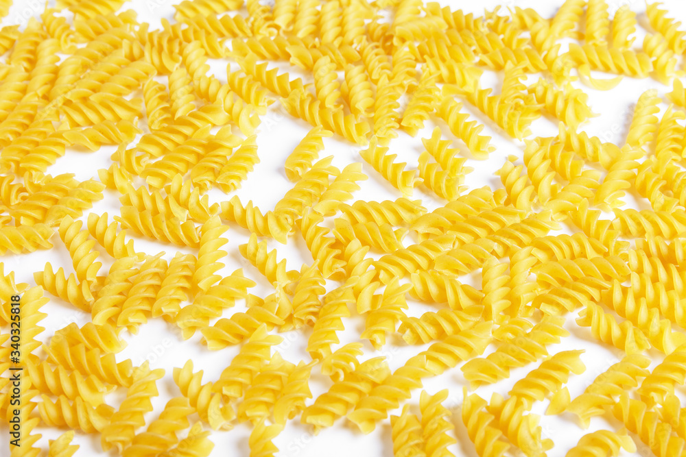 raw fusilli pasta on a white background. raw fusilli pasta on a white background.