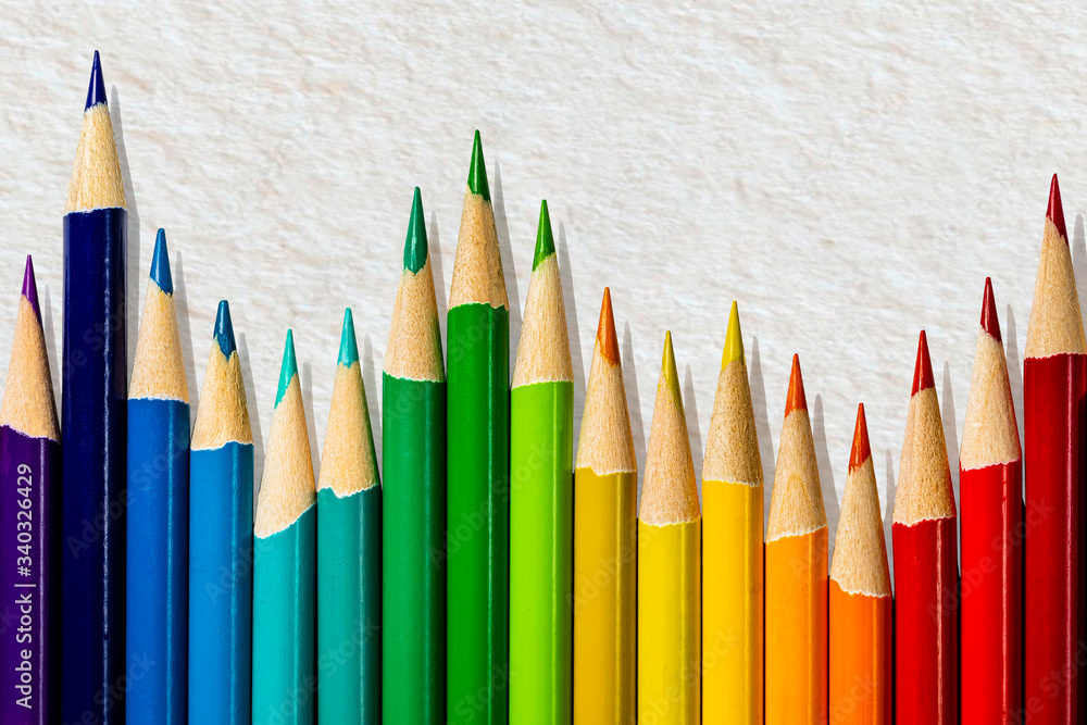 A business bar chart composed of the sharpened ends of a set of professional artist's colored pencils on a dirty linen fiber paper background. Room for copy writing above the pencils on the background A business bar chart composed of the sharpened ends of a set of professional artist's colored pencils on a dirty linen fiber paper background. Room for copy writing above the pencils on the background