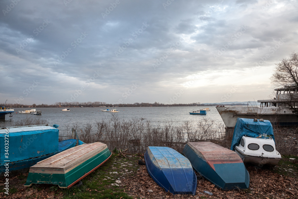 Boats and ships, some fishing ships and old and rusty abandoned boats standing on the riverbanks of the river Dabube on Zemunski Kej, in Zemun, a suburb of Belgrade, Serbia