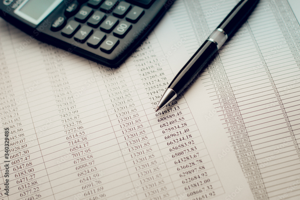 black pen on a sheet of paper with numbers and calculate black pen on a sheet of paper with numbers and calculate