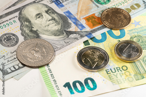 Dollar and Euro, 100 denomination. Banknotes and coins in different currency. US and European money on white background