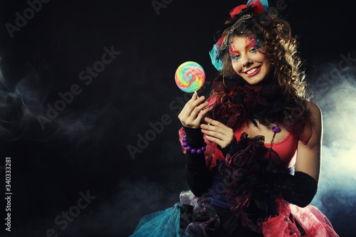 woman with creative make-up in doll style with candy. photo