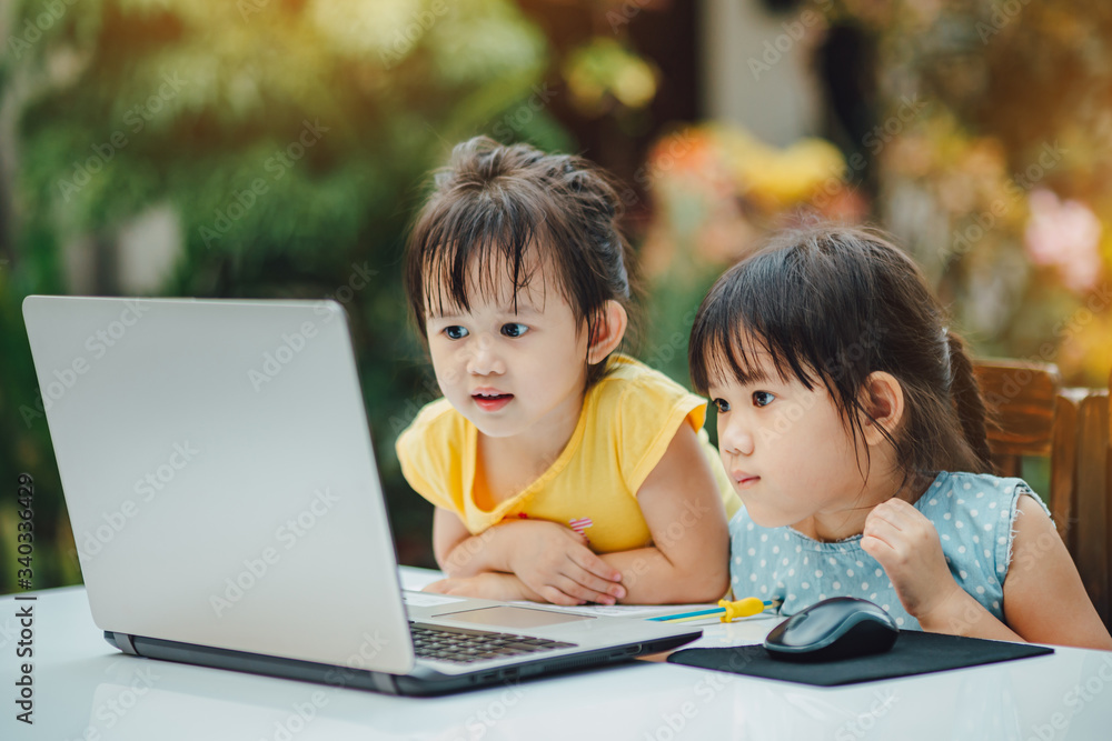 Kids studying at home during quarantine period for prevention of coronavirus or covid-19 outbreak. Home school or remote learning with parents helping children study at home for coping virus spreading Kids studying at home during quarantine period for prevention of coronavirus or covid-19 outbreak. Home school or remote learning with parents helping children study at home for coping virus spreading