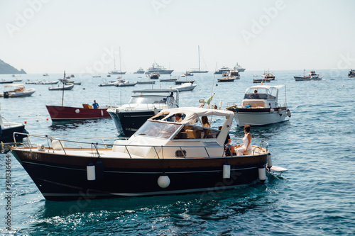 a small yacht moored off the coast of Positato Italy