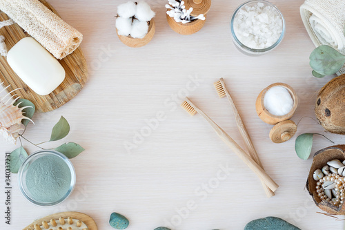 Oral care with natural cosmetics and baboo toothbrush. Flat lay spa composition with aloe vera and candles on wooden background. copy space. Beautiful medical homemade cosmetic products concept