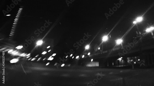 Urban time lapse with wide-angle of view. Shaky handheld fisheye lens clip. Blurry night street road traffic.