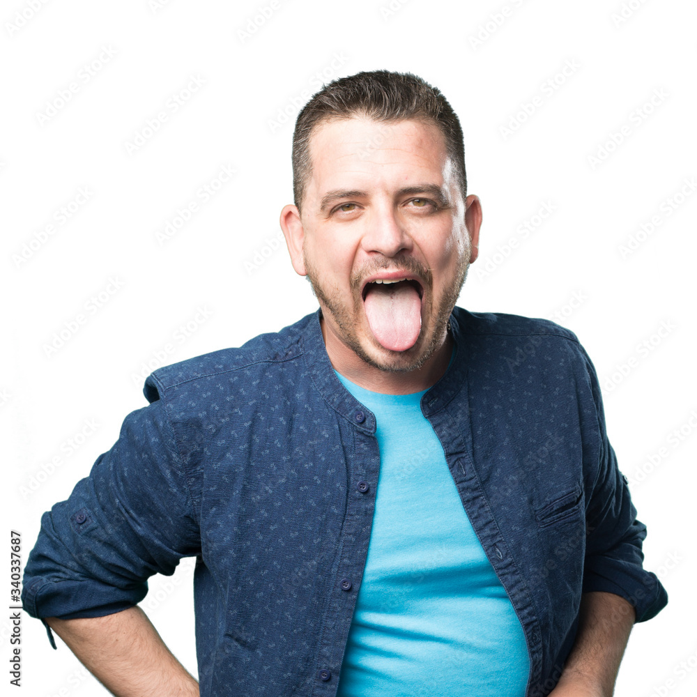 Obraz premium Young man wearing a blue outfit. Pulling his tongue out.