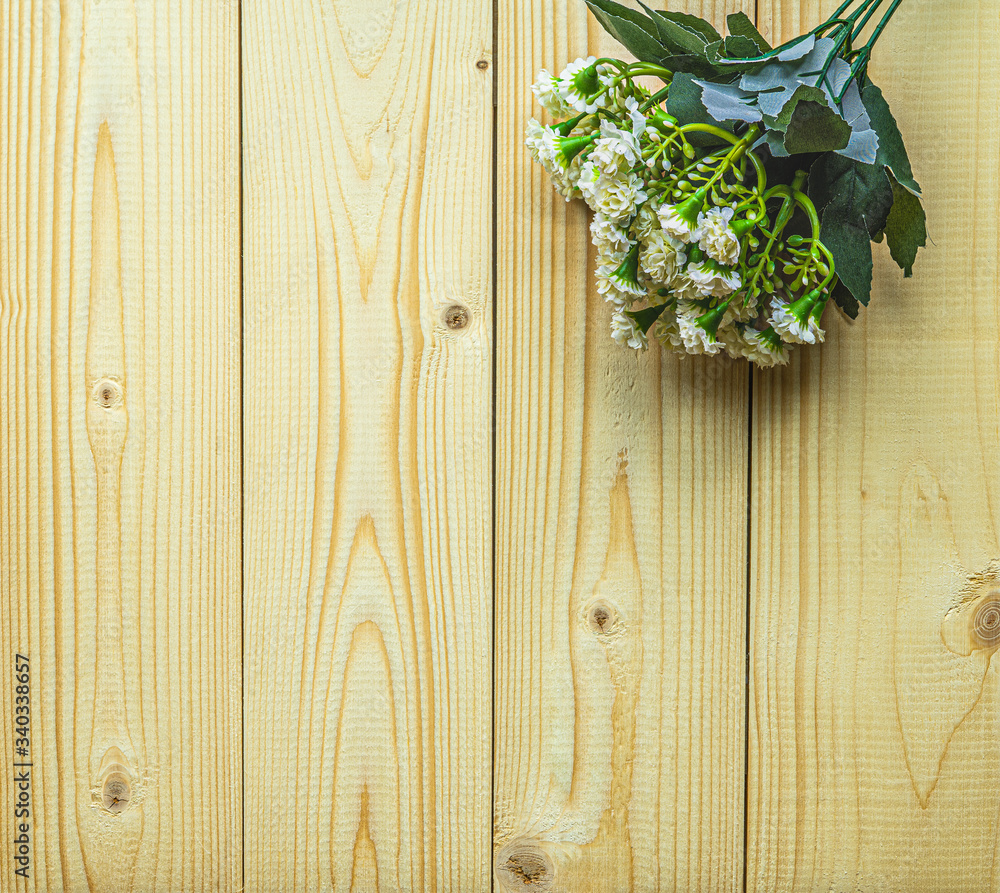 The beautiful Artificial white flowers From plastic Placed on the top right Of yellow plank With a copy space The beautiful Artificial white flowers From plastic Placed on the top right Of yellow plank With a copy space