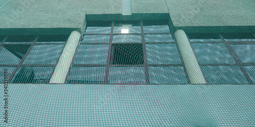 Facade of a building protected with nylon netting, common buildin site work method.